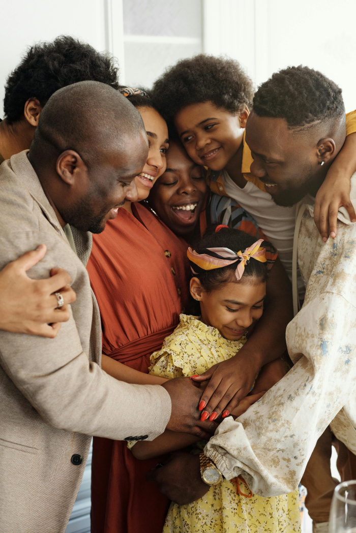 a family of 6 hugging each other and smiling