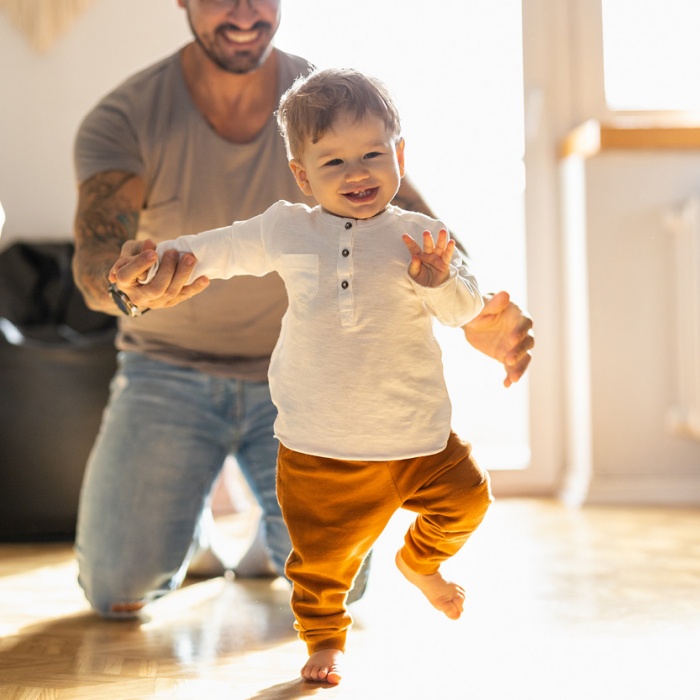 Father teaching his son how to walk