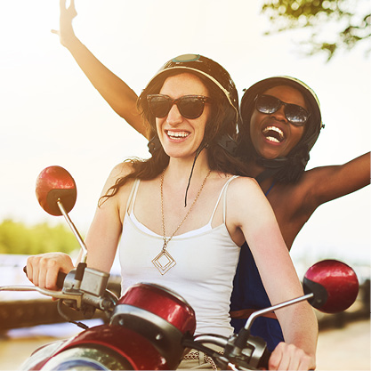 young women in retro helmets riding motorcycle